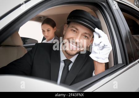 https://l450v.alamy.com/450v/2f43fnx/handsome-chauffeur-driving-luxury-car-2f43fnx.jpg