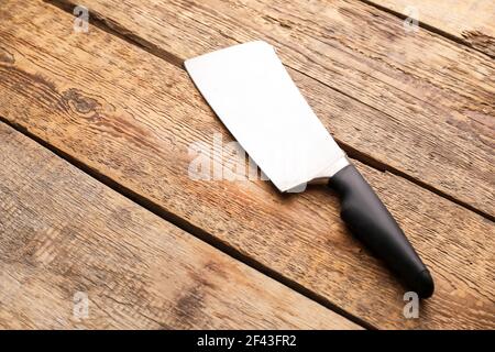 Knife with black handle on wooden background Stock Photo