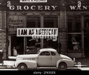Wanto Co. store located at 401 - 403 Eighth and Franklin Streets in Oakland, California. The business was owned by the Matsuda family. Tatsuro Matsuda, a University of California graduate, commissioned and installed the 'I am an American' sign.Photograph by Dorothea Lange. Stock Photo
