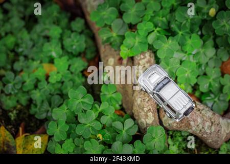 Funny concept of SUV adventure in the wide, miniature toy car in garden, top view, outdoor daytime Stock Photo