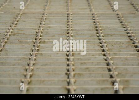 Low angle of outdoor metal grating walkway on sunlight warm lighting. Stock Photo