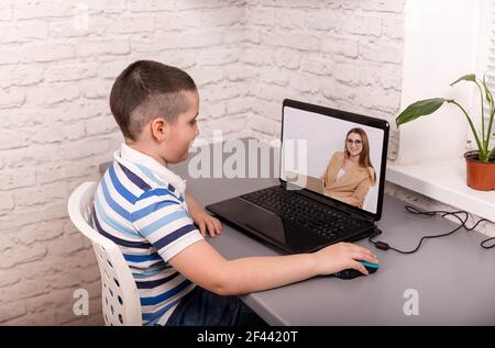 Cute boy taking online courses. Online education and e-learning. Stock Photo