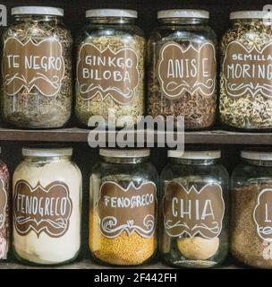 Jars on a store shelf labled with various spices. Stock Photo