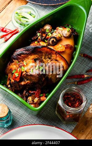 German cuisine meat dish of pork knuckle in baking dish.Meat food Stock Photo