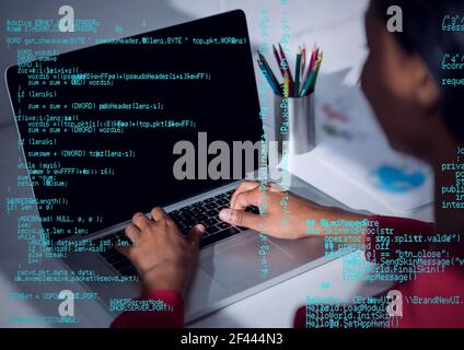 Composition of blue data processing over woman using laptop in background Stock Photo