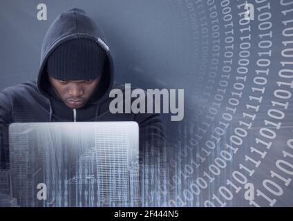 Composition of binary coding over hacker in hood using laptop Stock Photo