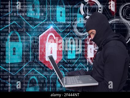 Composition of binary coding and online security padlocks over hacker in hood using laptop Stock Photo