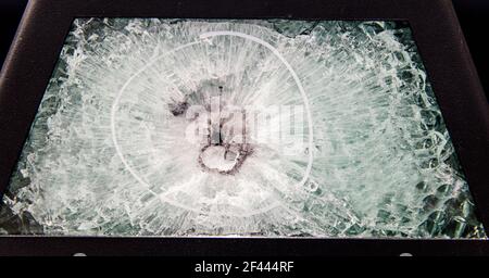 broken glass. Armored glass after impact. glass reinforced with a film after being hit by a bullet. Stock Photo