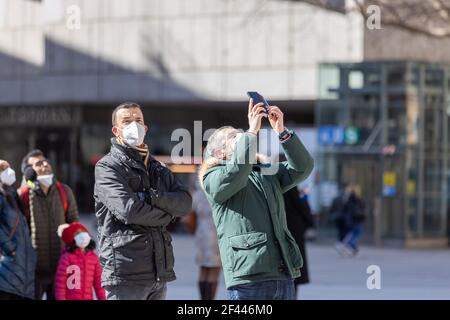 munich, germany - march 06 2020: locals and tourist enyjoing the famous 12 pm marienplatz carillon with face mask. Stock Photo