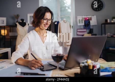 Designer using laptop and graphic tablet for work Stock Photo