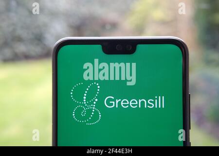 Greensill logo seen on the smartphone and blurred background. Greensill Capital was a financial services company which filed for insolvency. Stock Photo