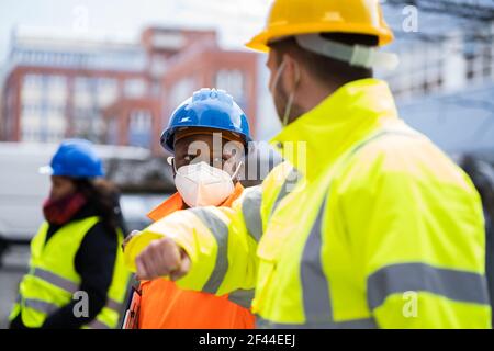 Construction Industry People Teamwork Elbow Bump Greeting Stock Photo