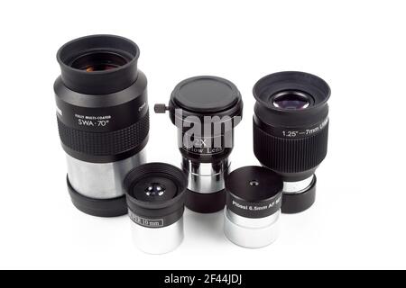 Telescope eyepieces and barlow lens on white background, isolate, close-up. Stock Photo