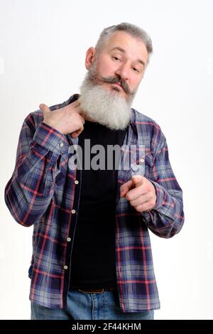 Studio portrait of mature bearded man in casual clothes gestures it is time to drink alcohol, bad habit concept, white backdrop Stock Photo