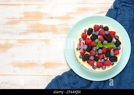 Homemade cake with fresh berries on wooden background. Stock Photo