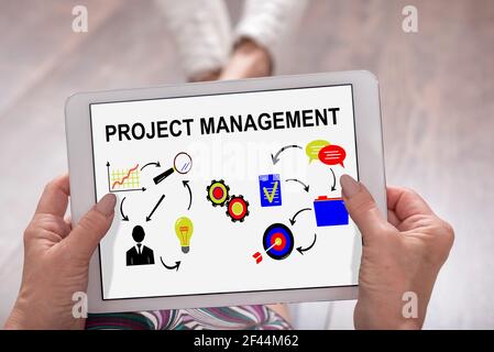 Project management concept shown on a tablet held by a woman Stock Photo