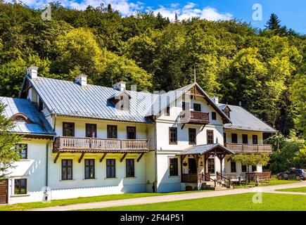 Ojcow, Poland - August 24, 2020: Historic wooden villa house Hotel Pod Kazimierzem and Ojcow National Park Museum in Pradnik creek valley Stock Photo