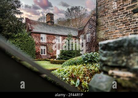 Whitley Hall Sheffield old stone cottage accommodation with Christmas tree and lights in romantic winter garden courtyard Stock Photo