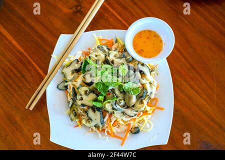 Seafood dishes on the table include fried rice, snail salad, steamed shrimp in the coastal seafood restaurant. Promote human nutrition Stock Photo