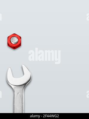 Open end wrench and red screw on white background Stock Photo