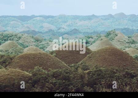 Chocolate Hills with a group of clouds in the sky Stock Photo