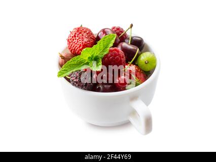 Fruits and berries in cup isolated on white background. Fruits and berries with copy space for text. Mix berries isolated on white background. Berries Stock Photo