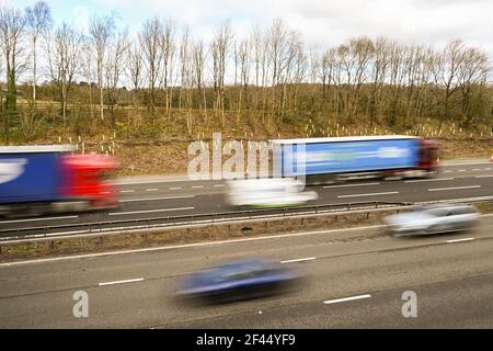 Miskin, Cardiff, Wales - March 2021: Traffic on the M4 motorway near Cardiff, with slow shutter speed to blur the motion of vehicles to convey speed Stock Photo