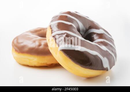 Delicious chocolate donuts on a white table. Food concept. Stock Photo