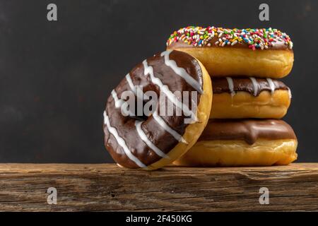 Delicious donuts on rustic wooden table. Food concept. Stock Photo