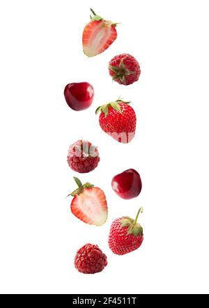 Isolated fresh berries float in the air. Falling strawberry, raspberry, cherry isolated on white background with clipping path. Mixed berries with a c Stock Photo