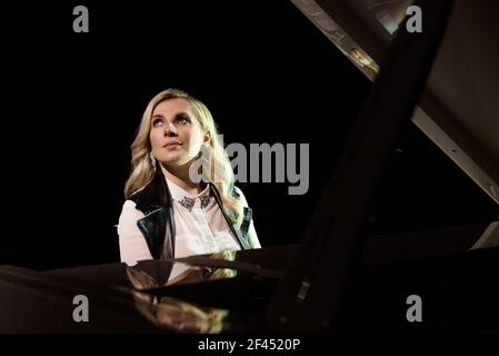 Close up view of a girl plays piano in the concert hall at scene Stock Photo