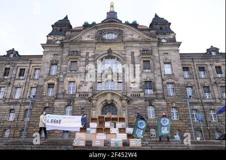 Dresden, Germany. 19th Mar, 2021. Activists from Fridays for Future stand in front of the Saxon State Chancellery next to an installation made of empty cardboard boxes. On March 19, 2021, climate activists in more than 200 German cities began their protest actions against current climate policies. Credit: Sebastian Kahnert/dpa-Zentralbild/dpa/Alamy Live News Stock Photo