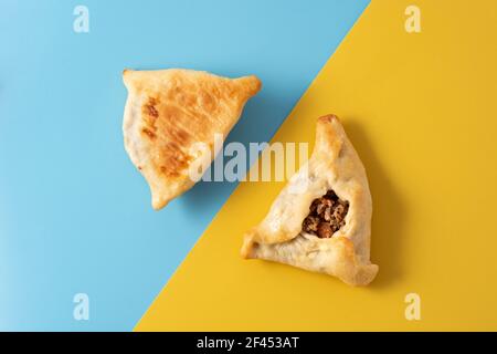 Traditional middle eastern fatayer on yellow and blue background Stock Photo