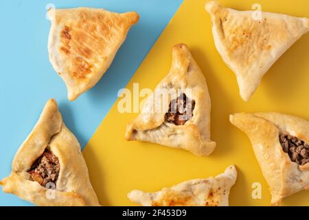 Traditional middle eastern fatayer on yellow and blue background Stock Photo