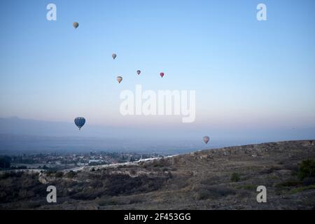 Multicolored hot air balloons flying in sunrise sky. Stock Photo