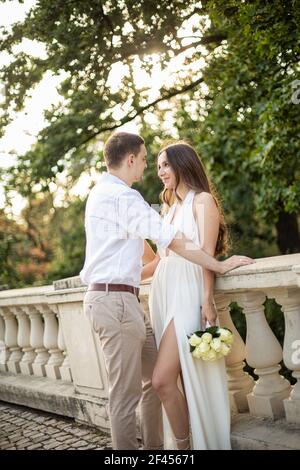 Young white couple in park in white clothes wedding Stock Photo