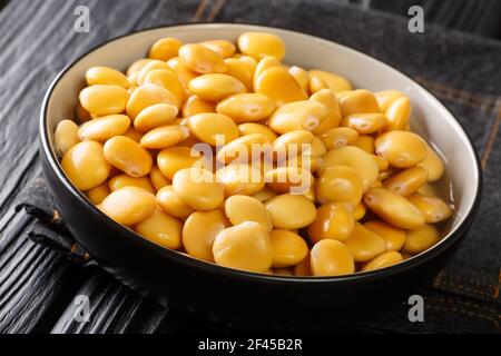 Healthy vegetarian pickled lupine beans close-up in a bowl on the table. horizontal Stock Photo