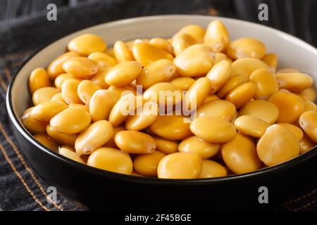 Traditional appetizer lupine beans close-up in a bowl on the table. horizontal Stock Photo