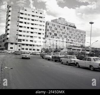 1960s, historical, modern high-rise apartment buildings and parked cars in a street in Jeddah, Saudi Arabia. Stock Photo