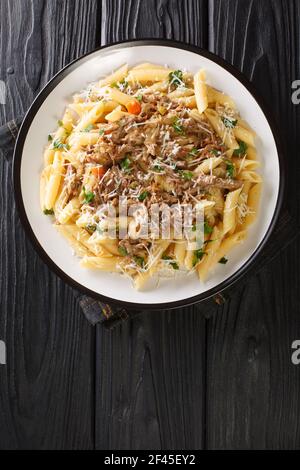 Genovese sauce is a rich, onion based pasta sauce served with pasta close up in the plate on the table. Vertical top view from above Stock Photo