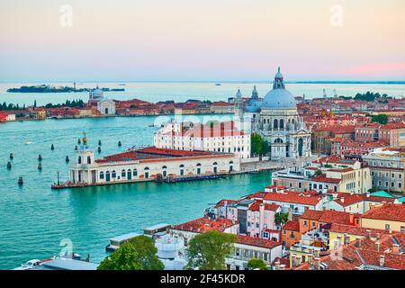 Venice in Italy. Panoramic view with The Grand Canal and Santa Maria della Salute church at dusk Stock Photo