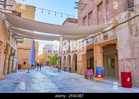 The pleasant walk in Al Fahidi neighborhood, popular for the restored adobe housing and many places of tourist interest, Dubai, UAE Stock Photo