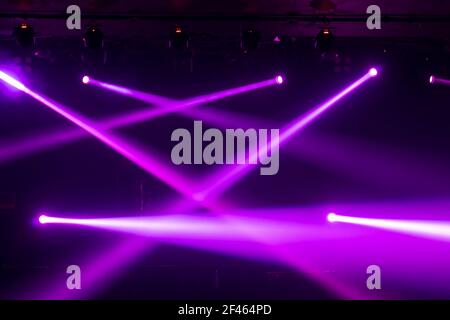 Abstract blurred photo of spotlight on the stage in conference hall or nightclub, silhouette audience or customer in restaurant,seminar and party envi Stock Photo