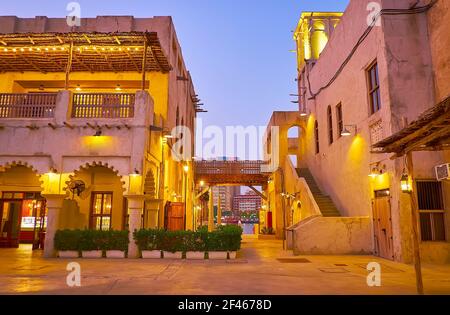 The scenic purple dusk sky over the clay medieval houses of Al Fahidi historic neighborhood, Dubai, UAE Stock Photo