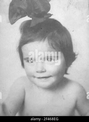 Album with portrait of a little girl. Quartercut with big hair bow Stock Photo