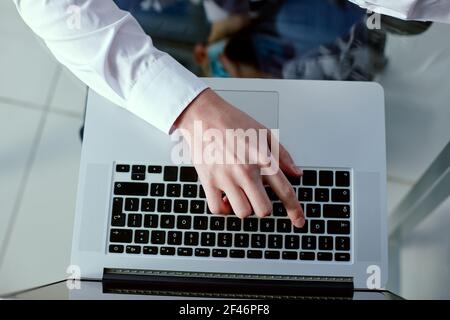 business man pressing a key with the number 7 on his laptop. Stock Photo