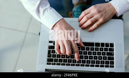 business man pressing a key with the number 7 on his laptop. Stock Photo