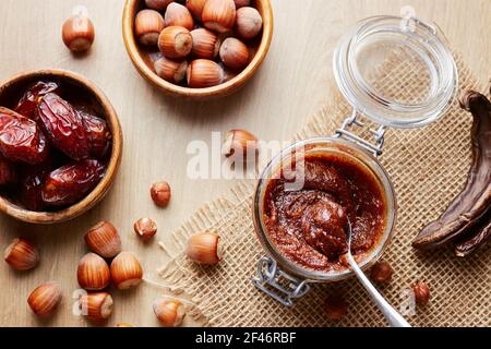 Jar of homemade chocolate hazelnut date spread with carob Stock Photo