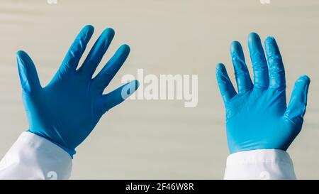 doctor is showing his hands in protective gloves . Stock Photo