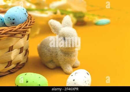 Cute bunny with colorful ester eggs in nests, spring and festive background photo Stock Photo